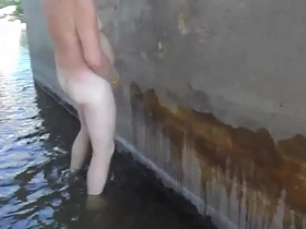 I water a bridge pylon while wading in the river